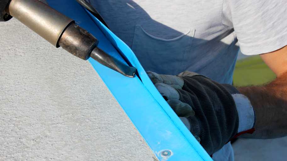 Close-up of a professional installing a pool liner
