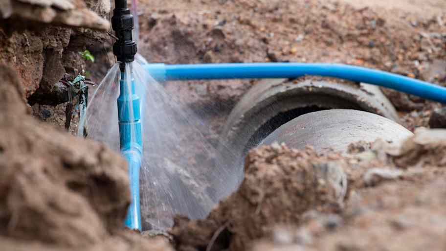 A broken water pipe is spraying water