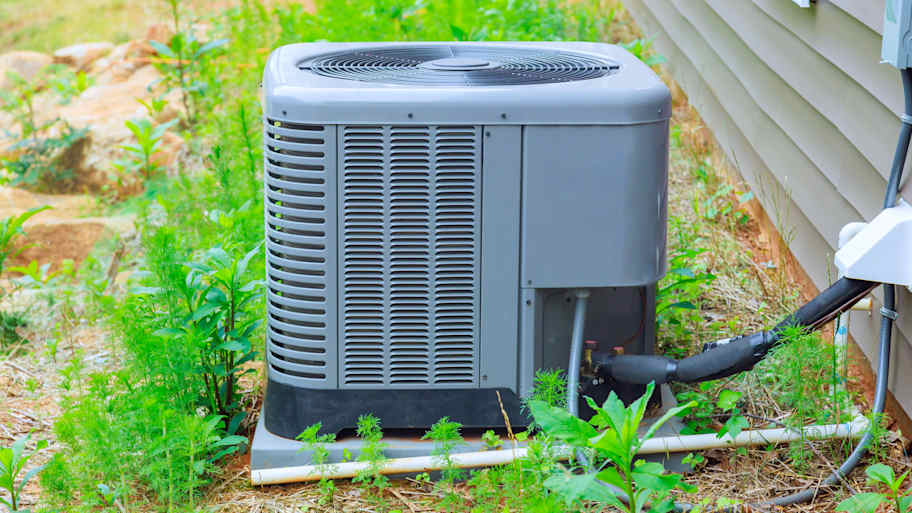 New air conditioner system unit sitting in the yard