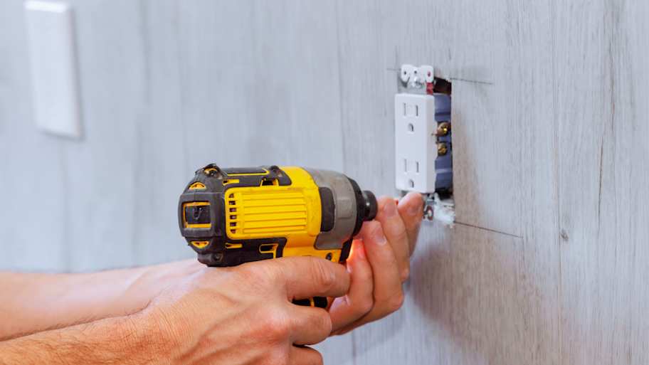 Electrician installing a new outlet in the kitchen   
