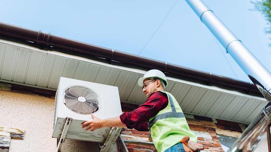 technician replacing ac