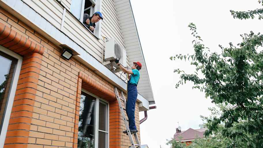 Worker repairing air conditioner