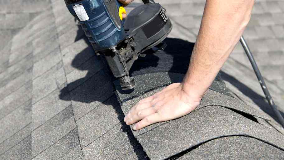 Worker installing shingles