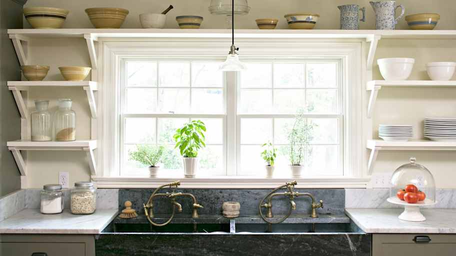 Open shelving surrounding a kitchen window