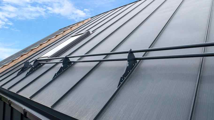 Snow guard railing installed on a metal roof 