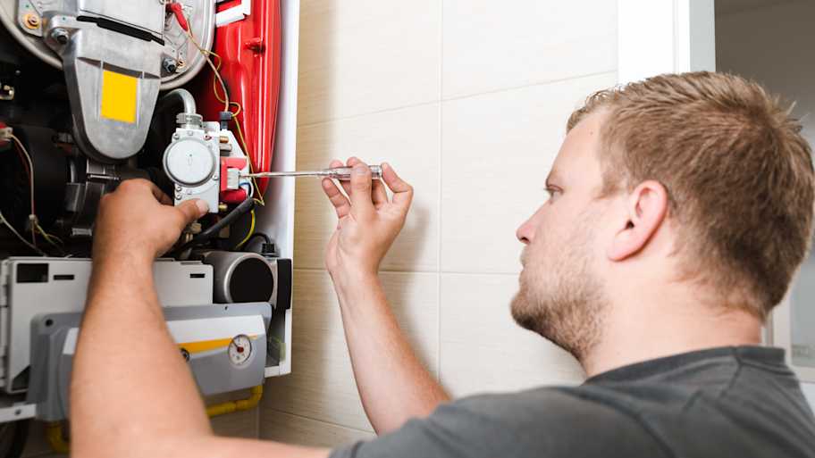 Technician repairing gas furnace 