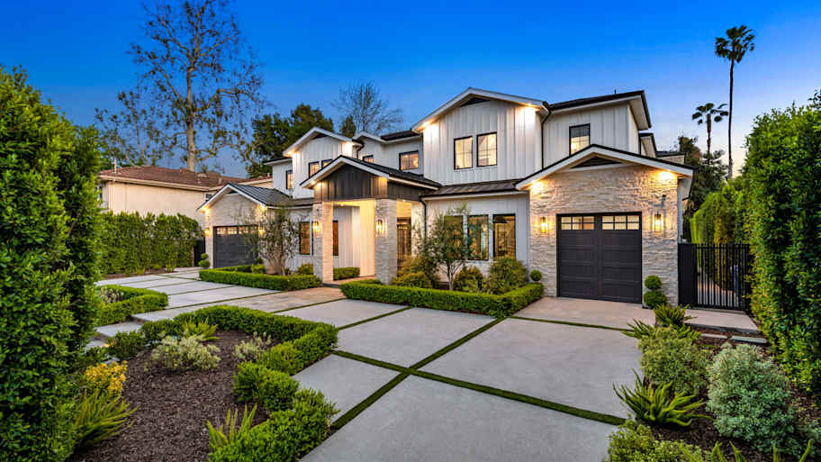 A modern suburban home with a well-maintained exterior is evaluated during a home appraisal to determine its market value.