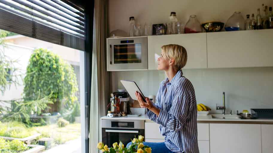 Woman closing metal blinds 