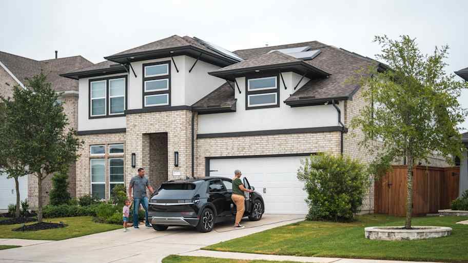 Family in front of a modern home