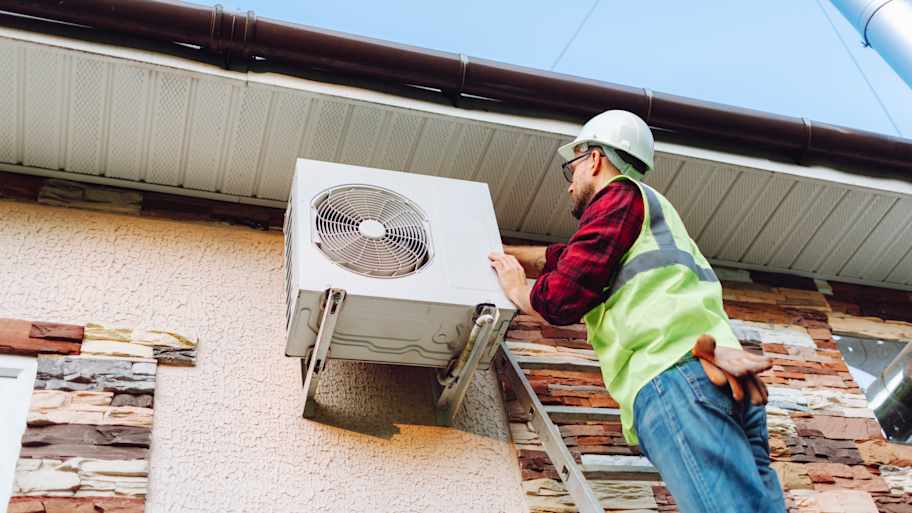Technician repairing heat pump  