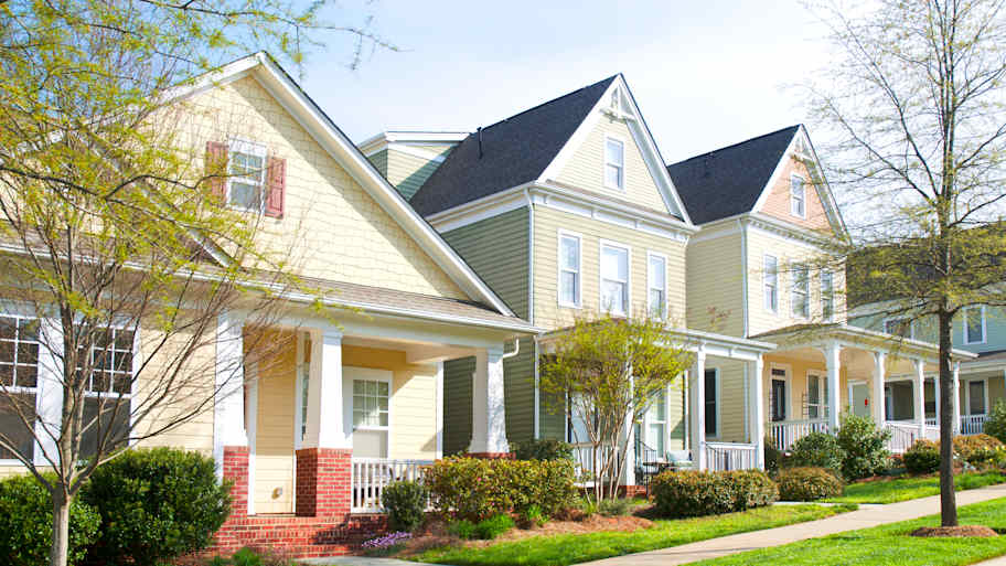 Row of houses with new vinyl siding and front porches  