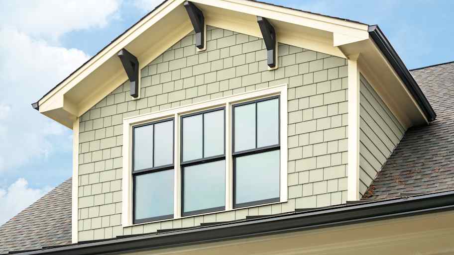 Vinyl shake siding installed on a dormer window