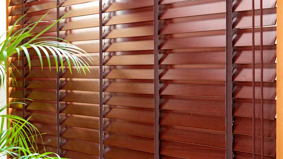 Wood window blinds installed in a room  