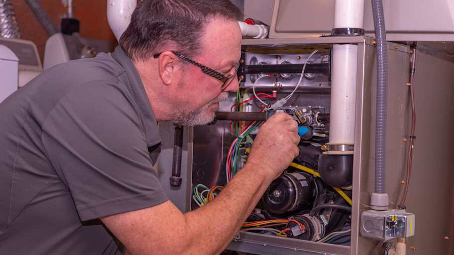 hvac tech installing new furnace