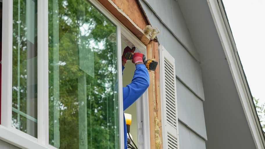A professional installing a new window 