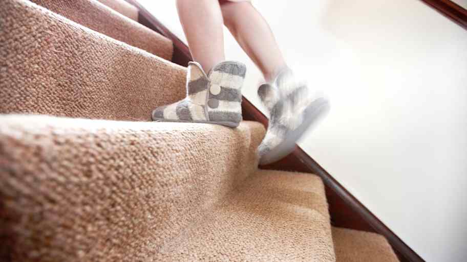 Person wearing sleepers is going upstairs 