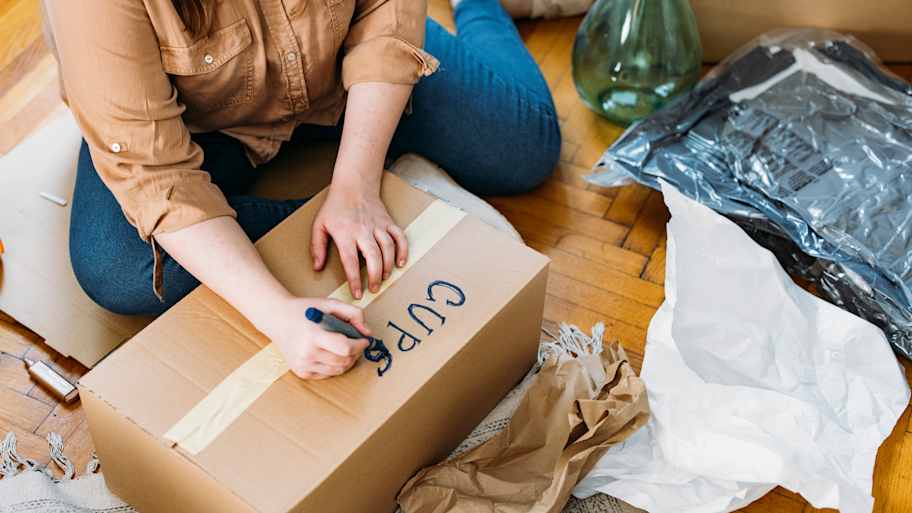 Woman labeling moving box