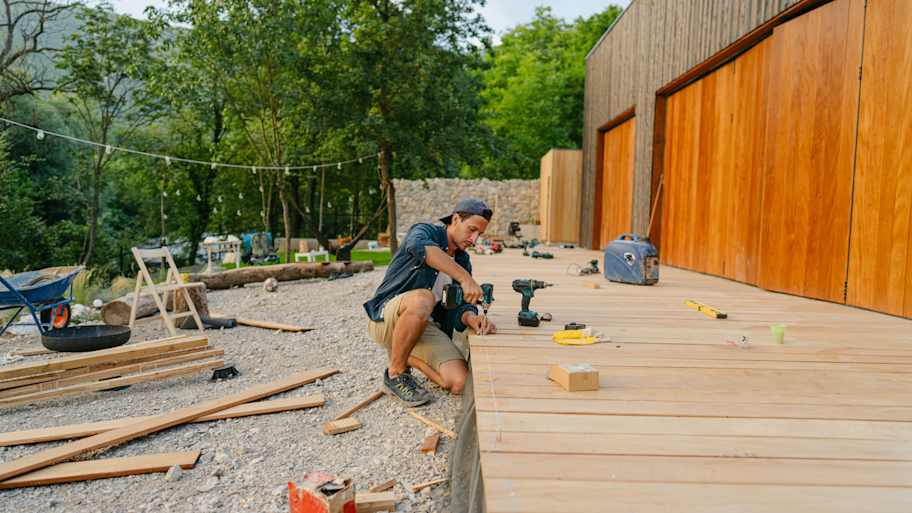 A man building a wooden deck