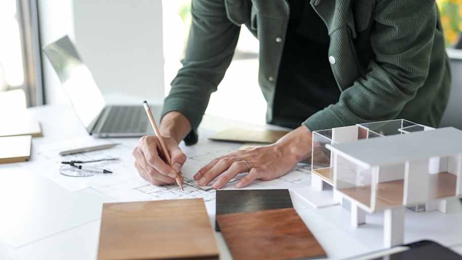 An architect designing kitchen blueprints