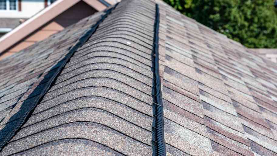 A roof ridge cap over the vent