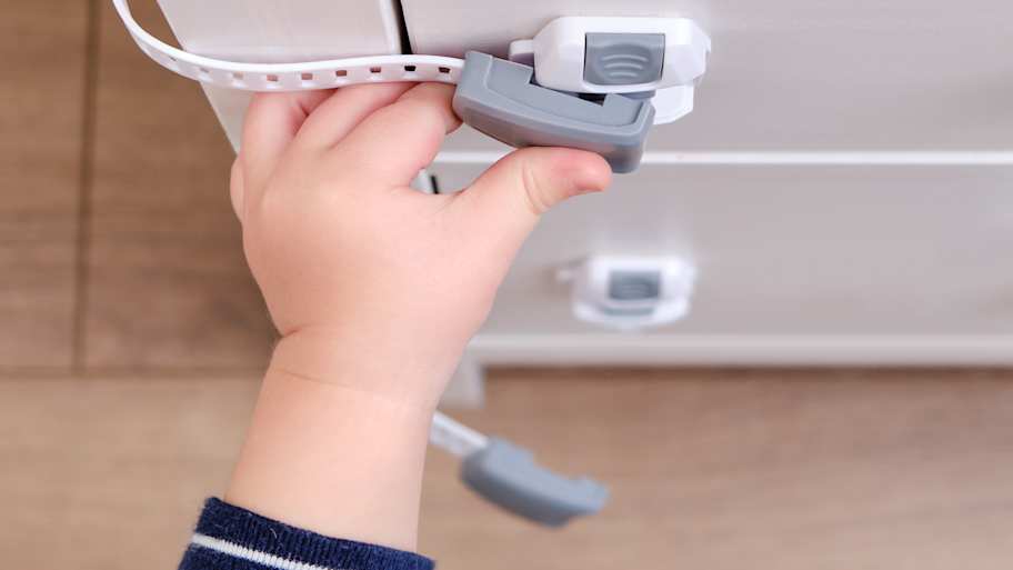 The child is locking the drawer