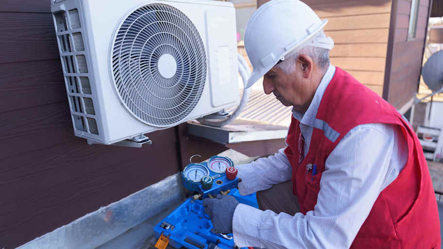 man performing maintenance check on mini split