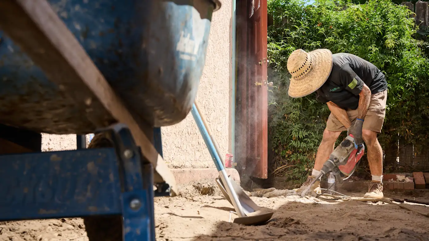 Man landscaping back yard.