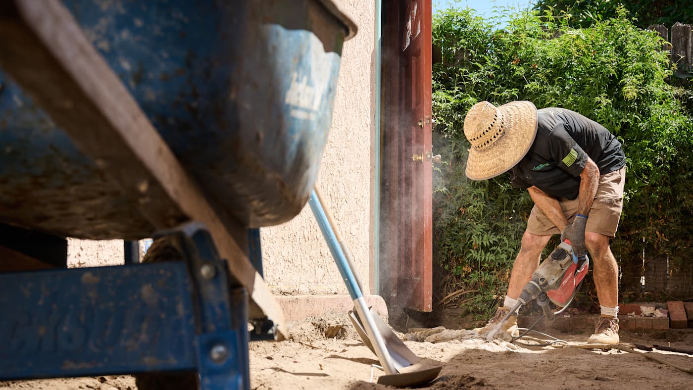 Man landscaping back yard.