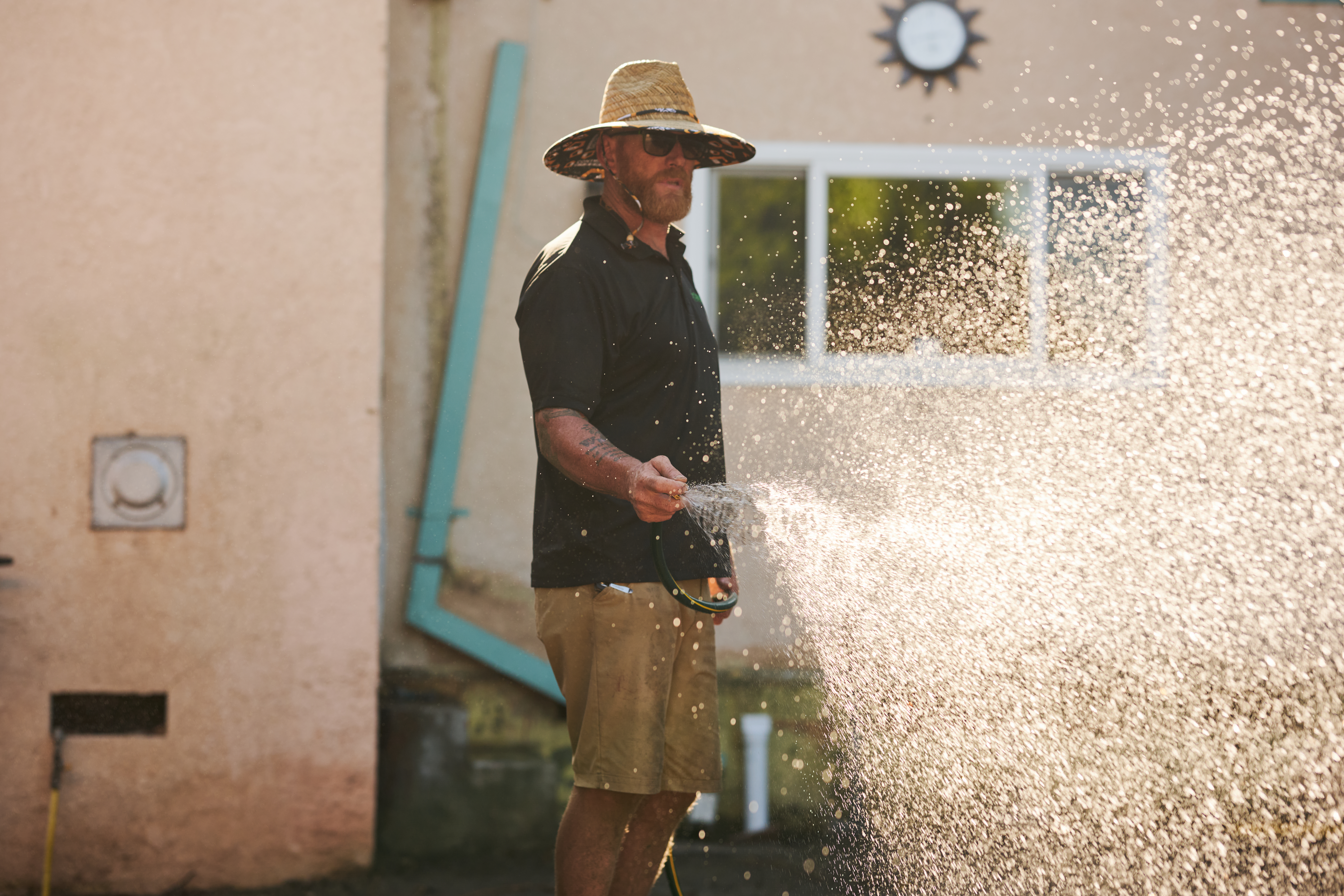 Man watering lawn.
