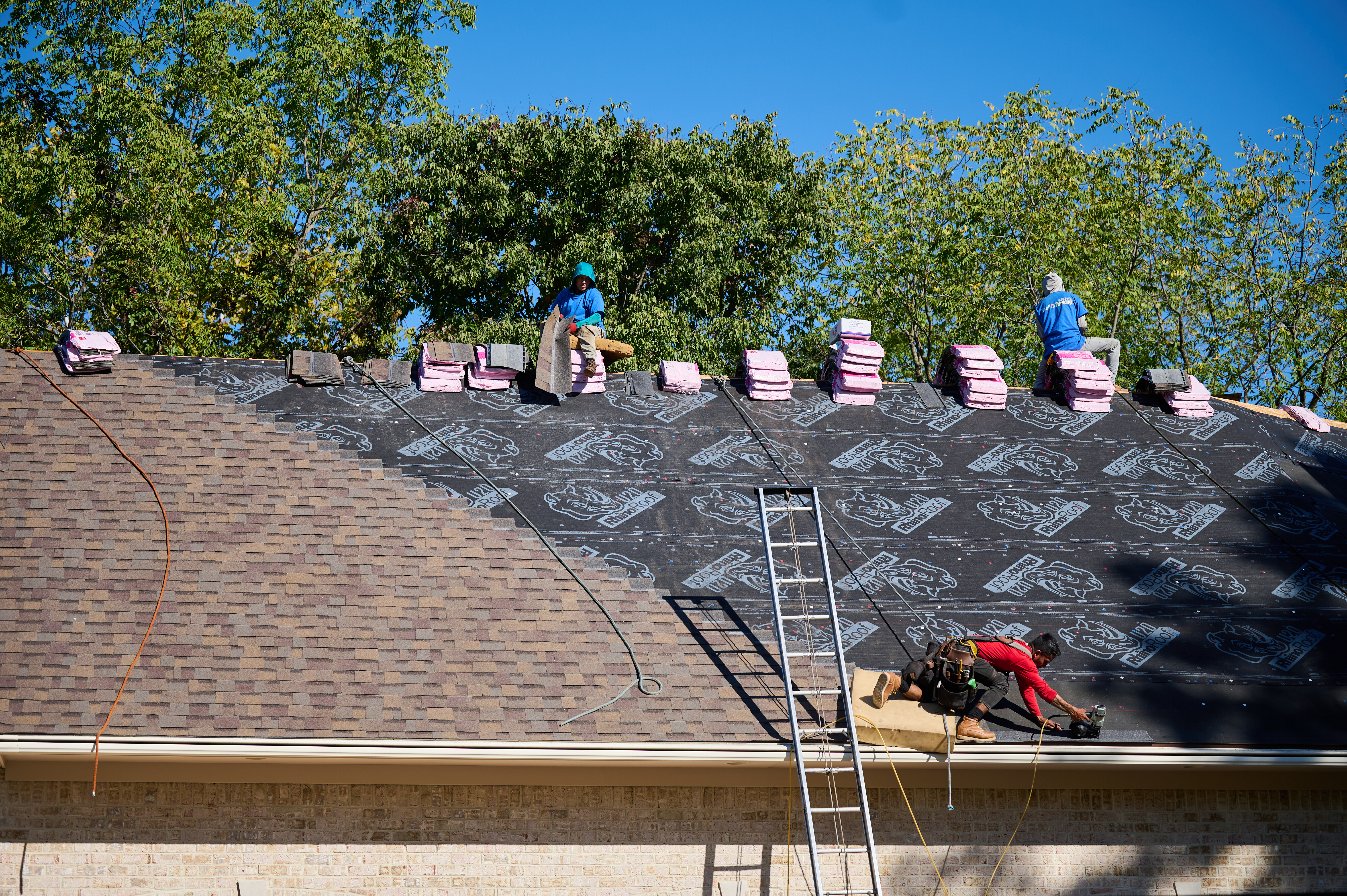 Man in red shirt repairing roof