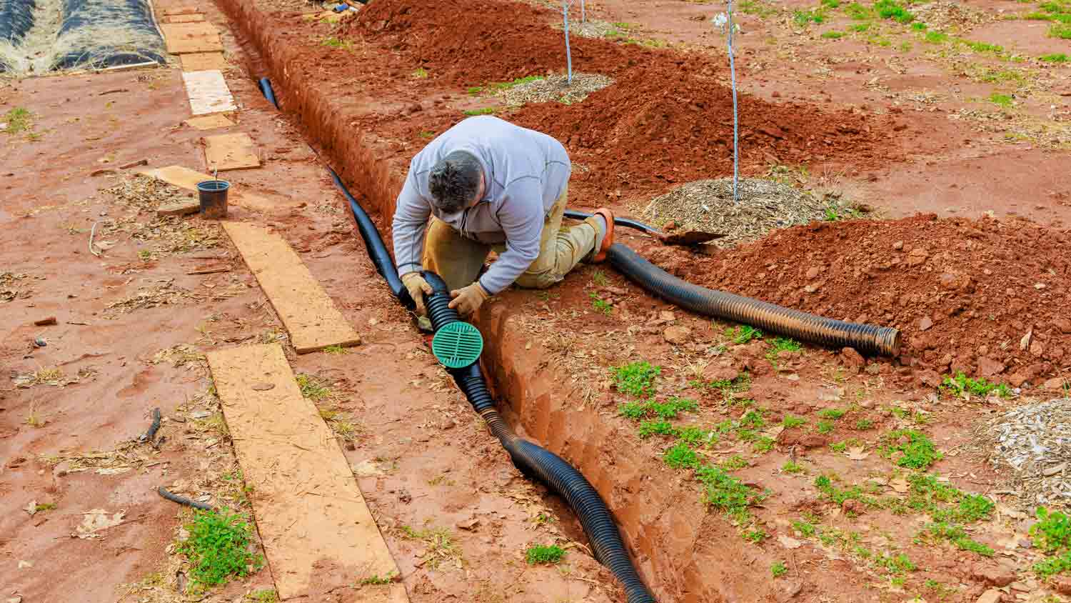 man installing trench drain
