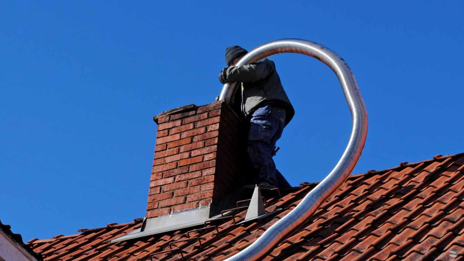 Worker installing chimney liner