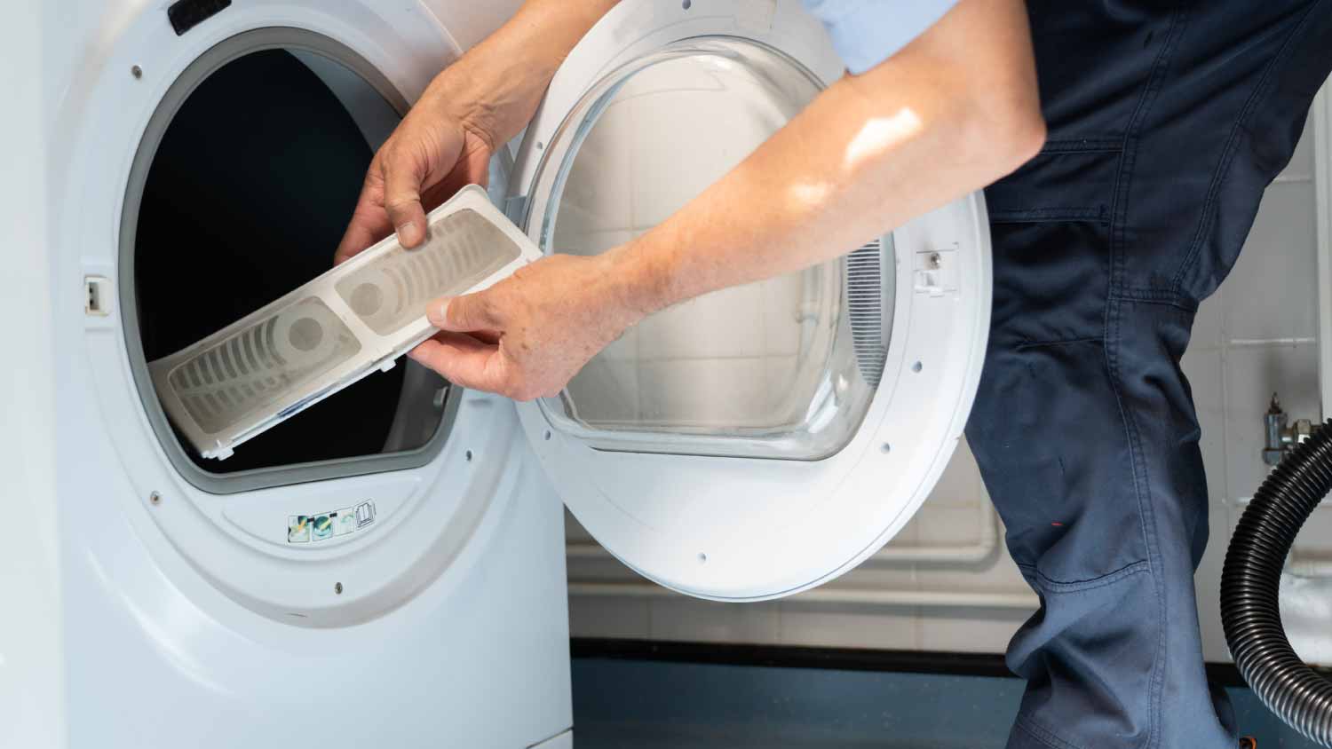 Worker repairing a tumble dryer