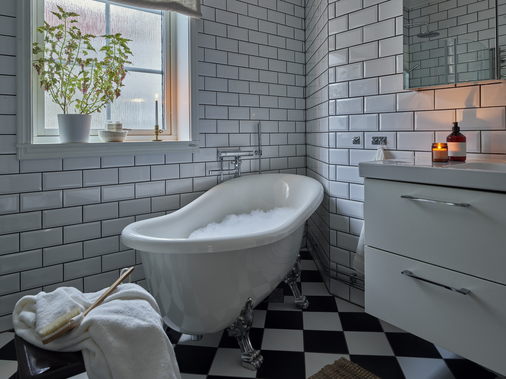 Free standing white bathtub in bathroom