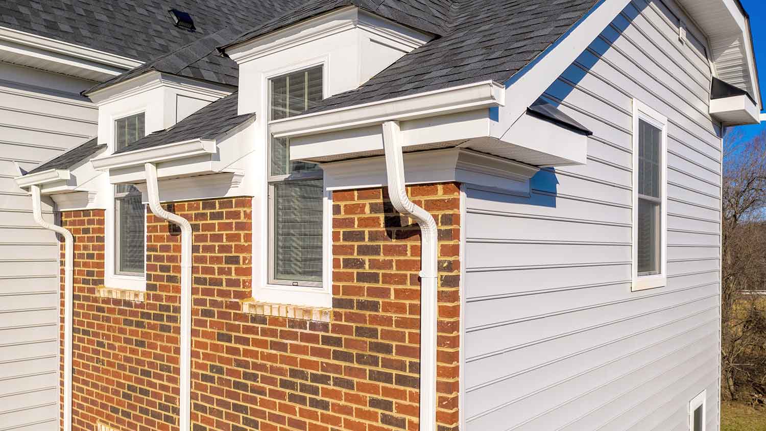 Copper rain gutter mounted on a stone wall