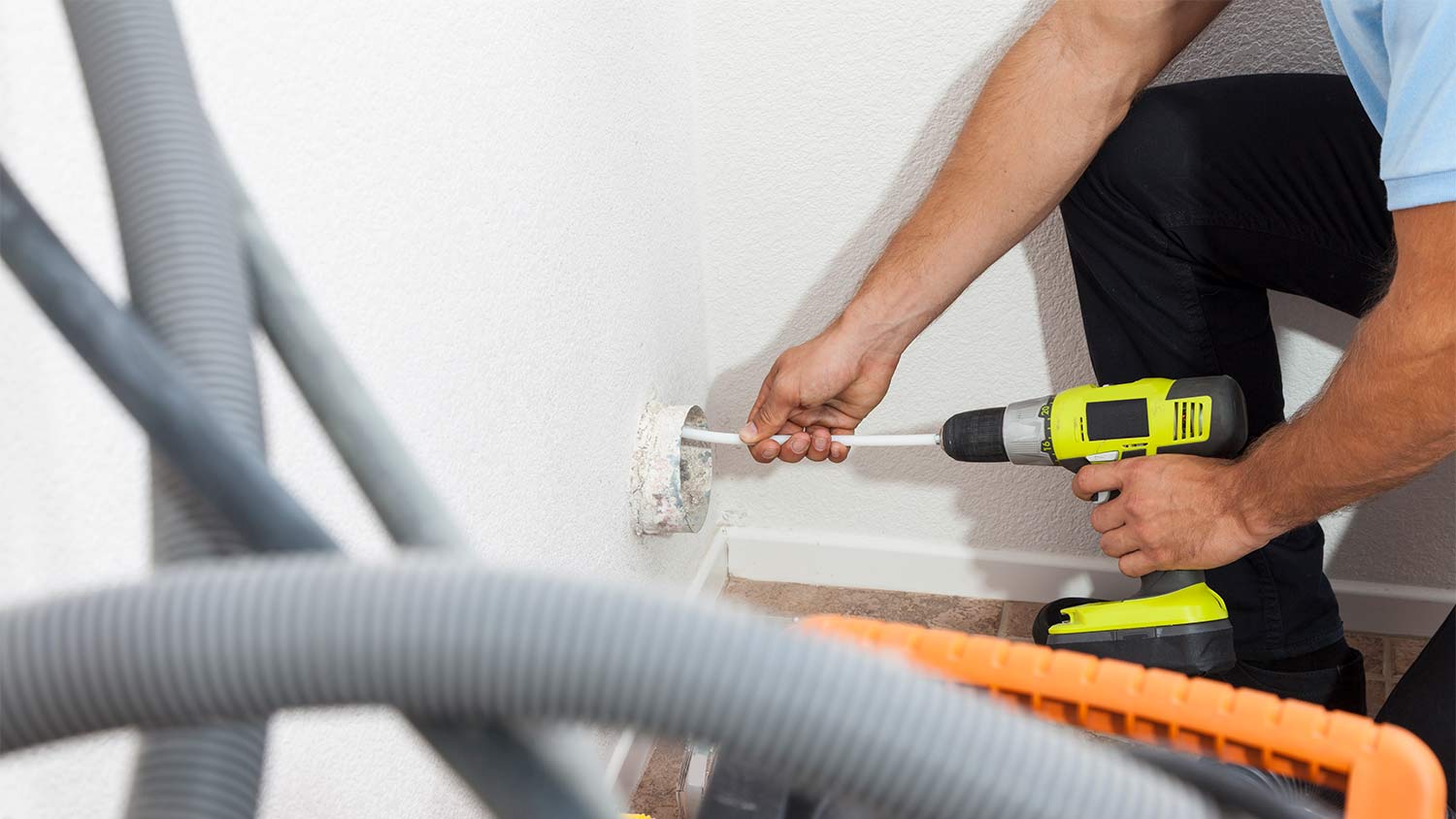 Man cleaning dryer vent
