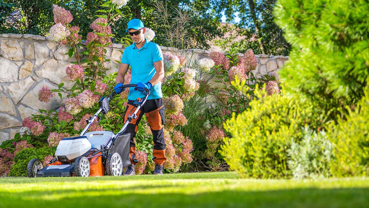 Lawn care professional mowing the lawn