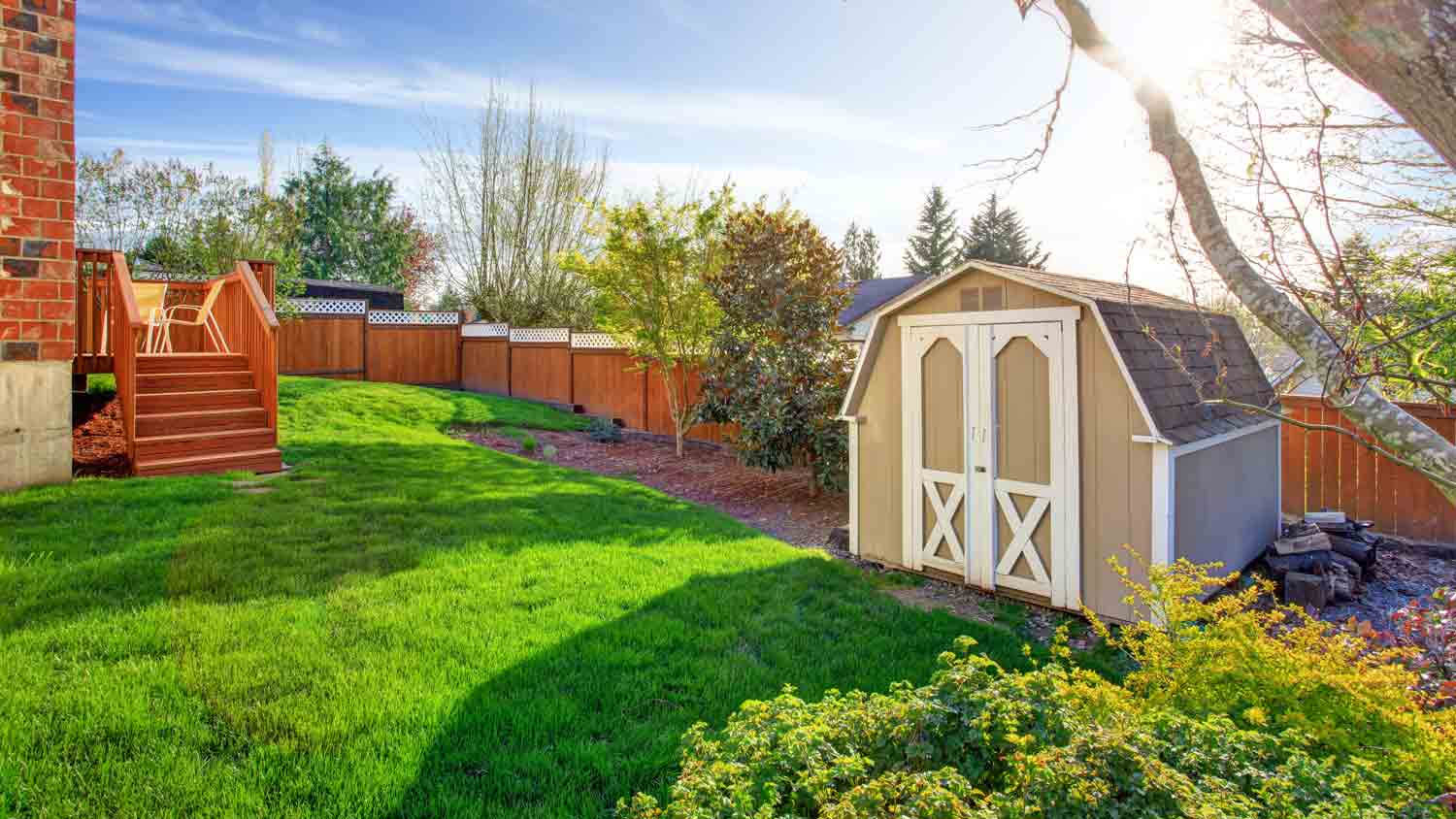 fenced backyard with small shed