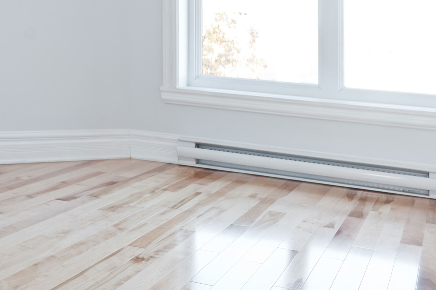 white empty room with baseboard heater