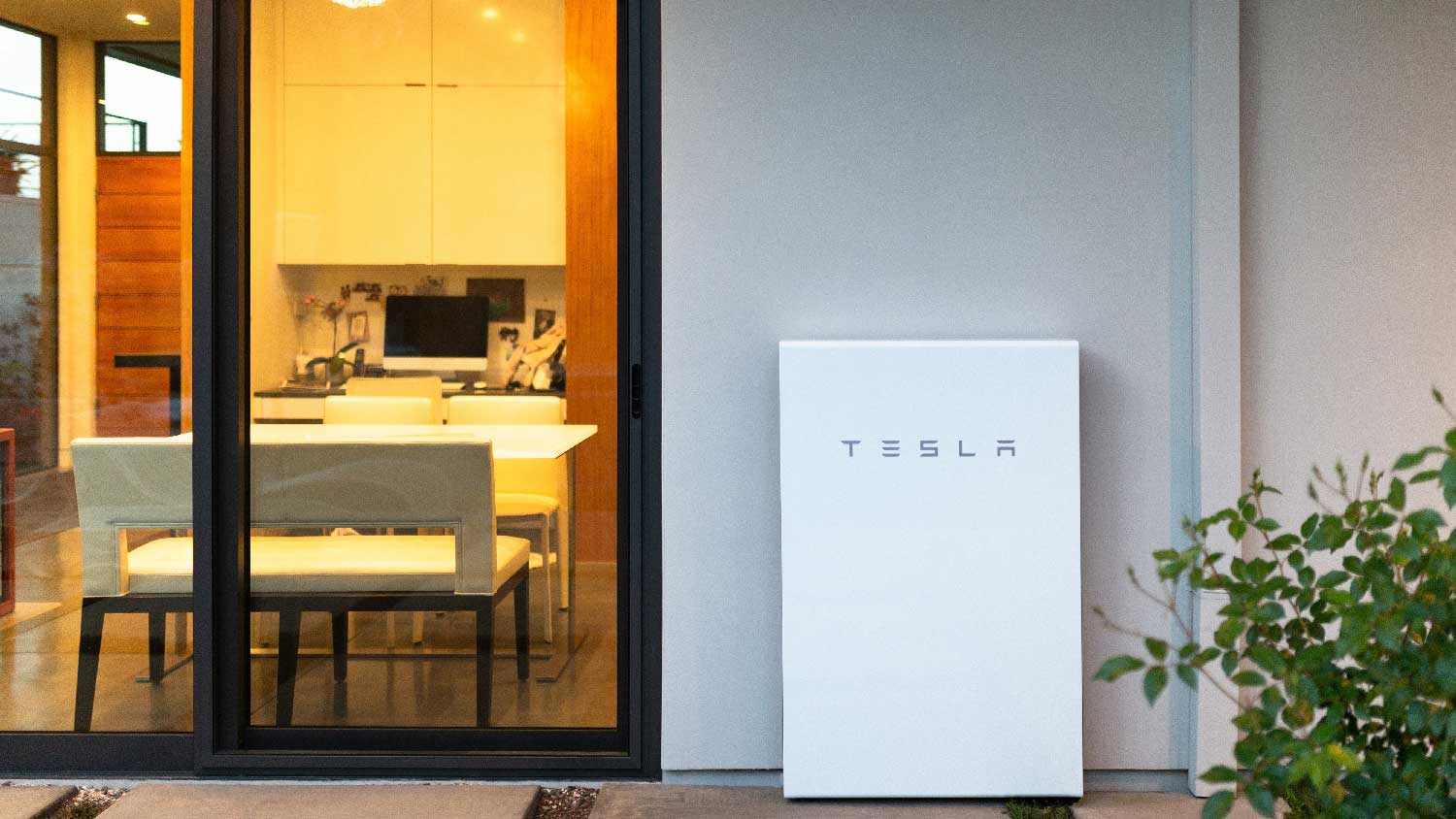 A Tesla Powerwall outside of a room