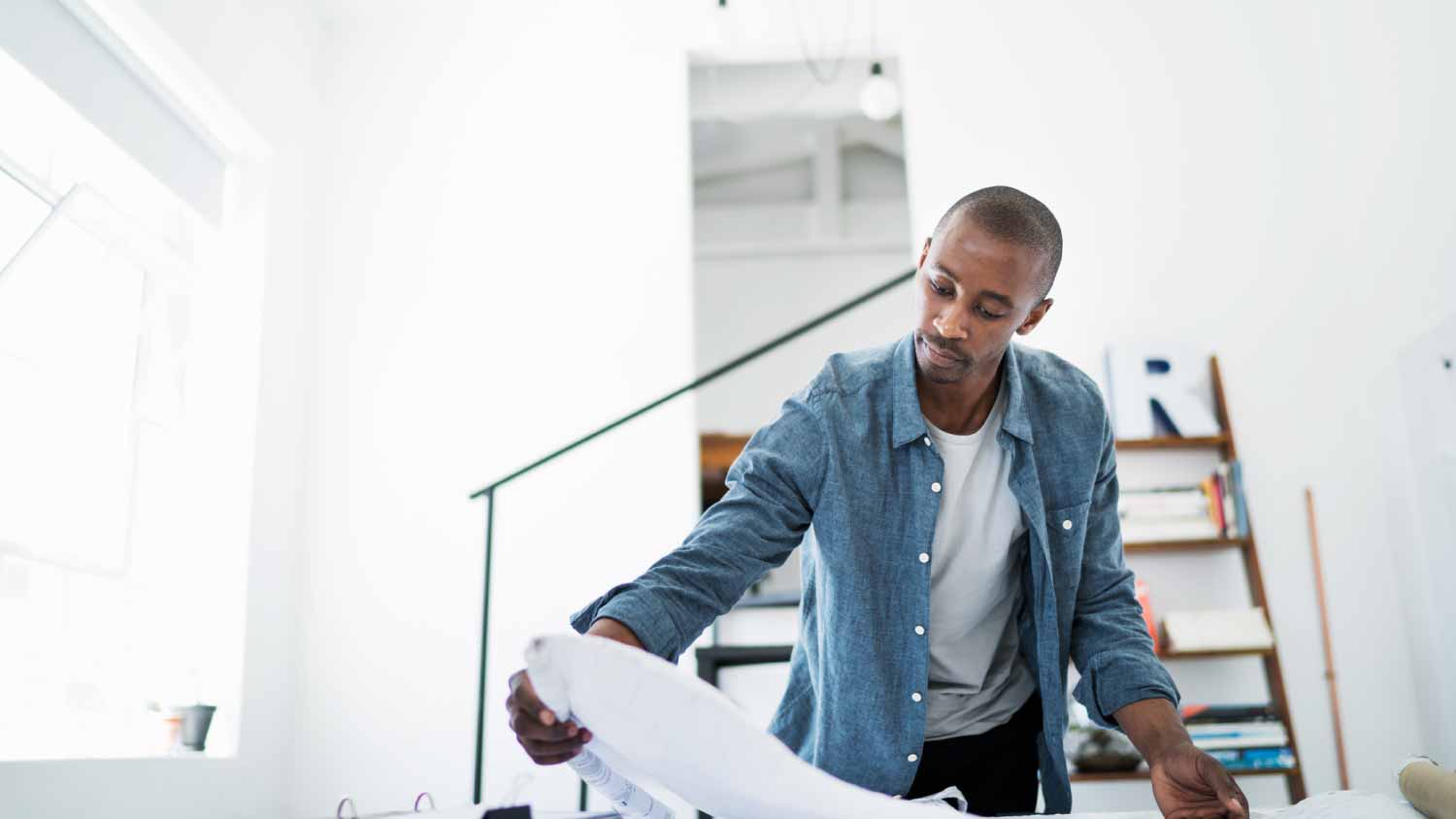 Architect reviewing blueprints