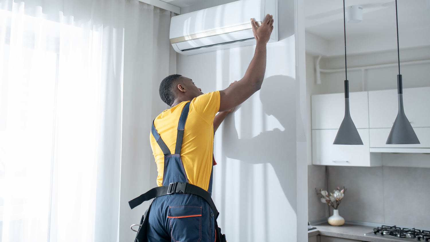 repairman fixing leaky ac