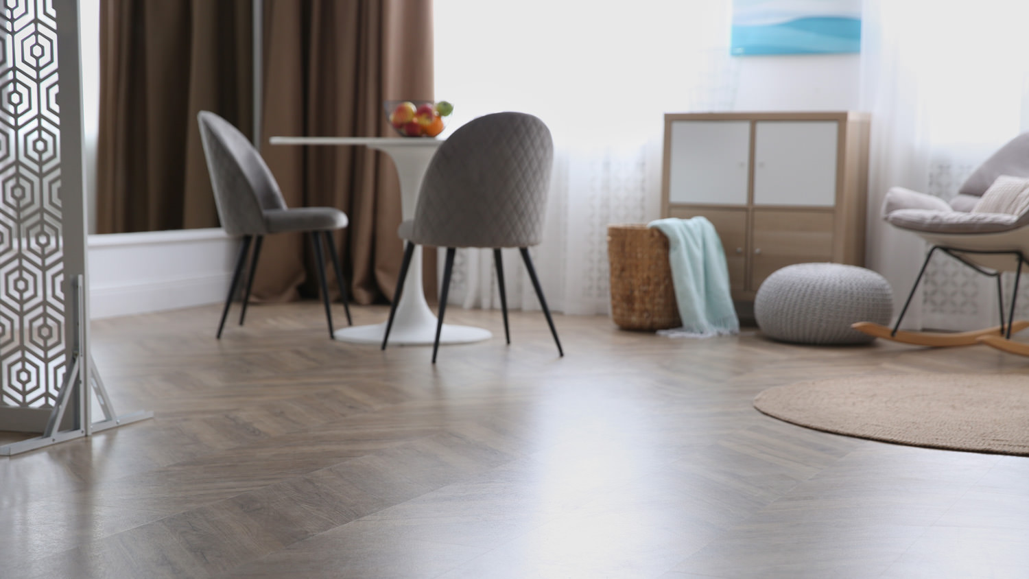 A modern living room with vinyl flooring and stylish furniture