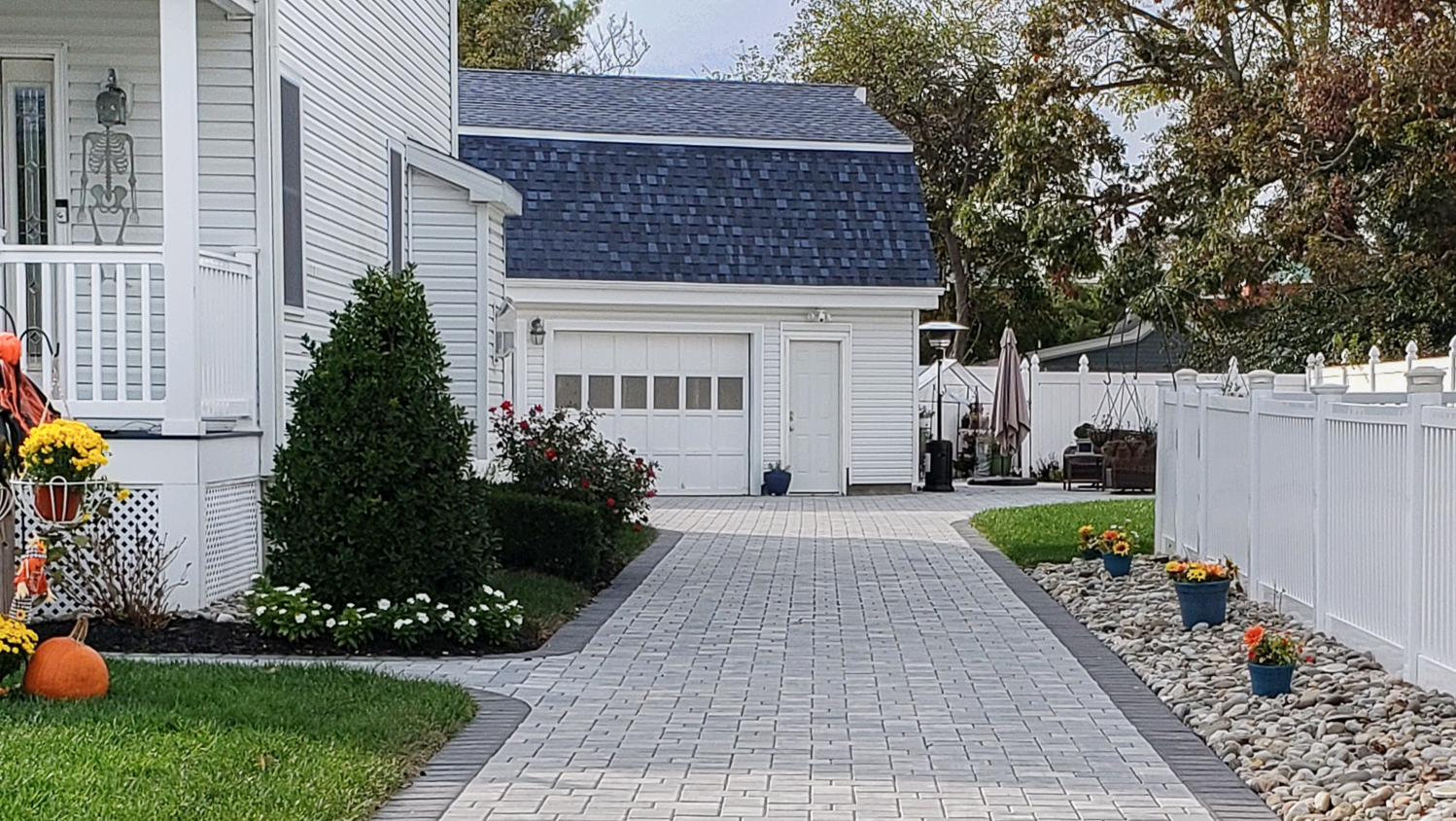 White house with gray paver driveway