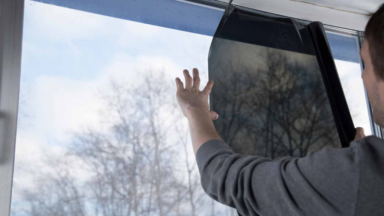 Man installing window film