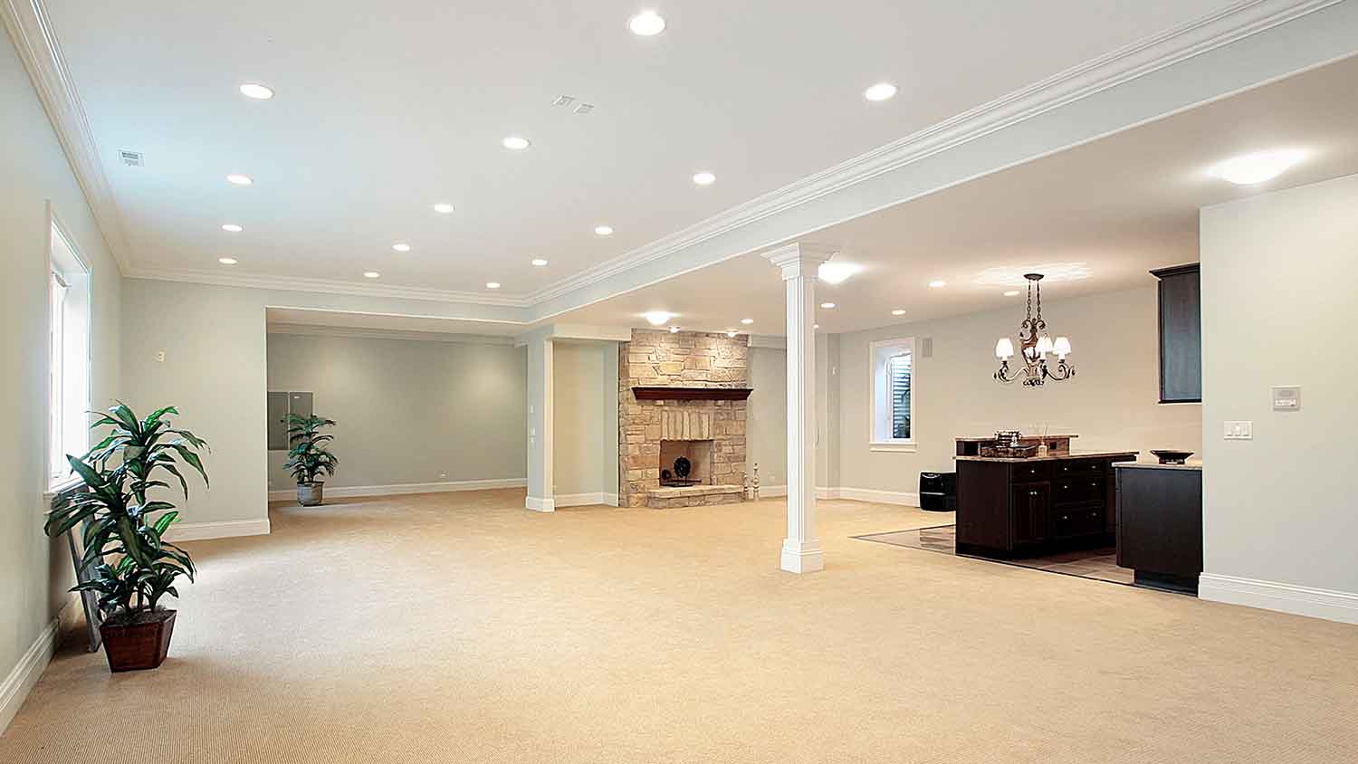 Finished basement with stone fireplace