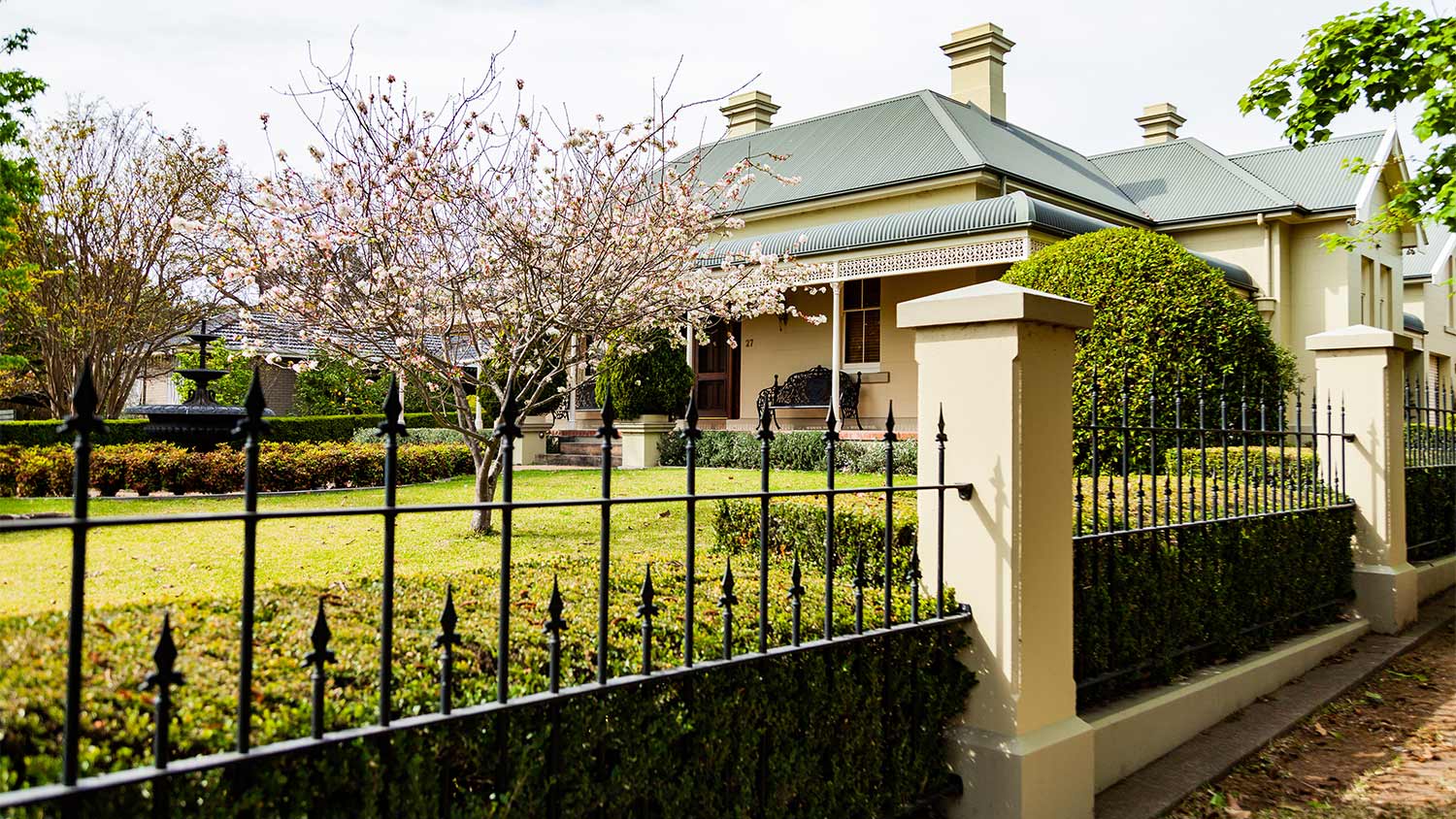 Cast iron fence around neat front yard