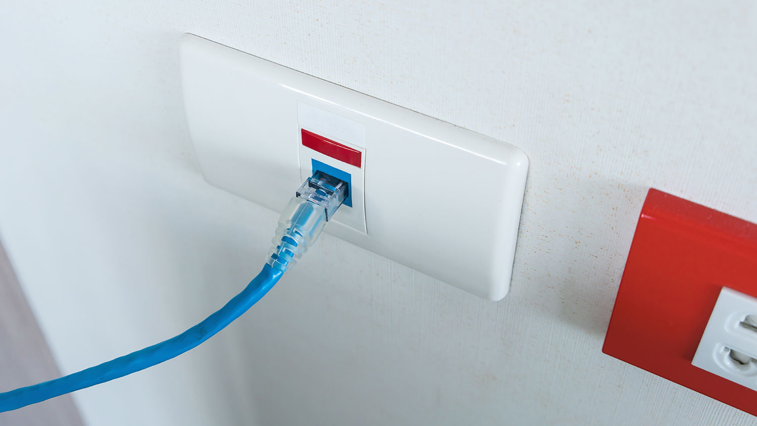 Ethernet cable connected to outlet wall plate