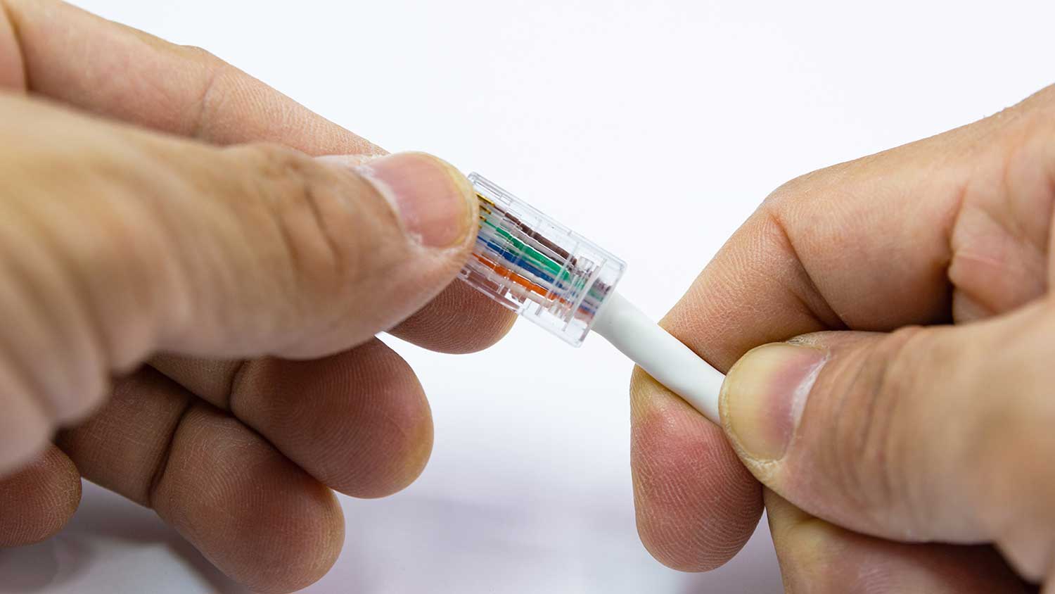 Hand installing connector end on an ethernet cable