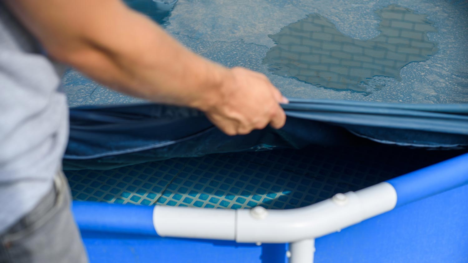 Close-up of a man covering a pool